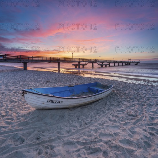 Pier on the fine sandy beach of the Baltic Sea at sunset, fishing boat on the beach, Baltic resort Rerik, Mecklenburg-Western Pomerania, Germany