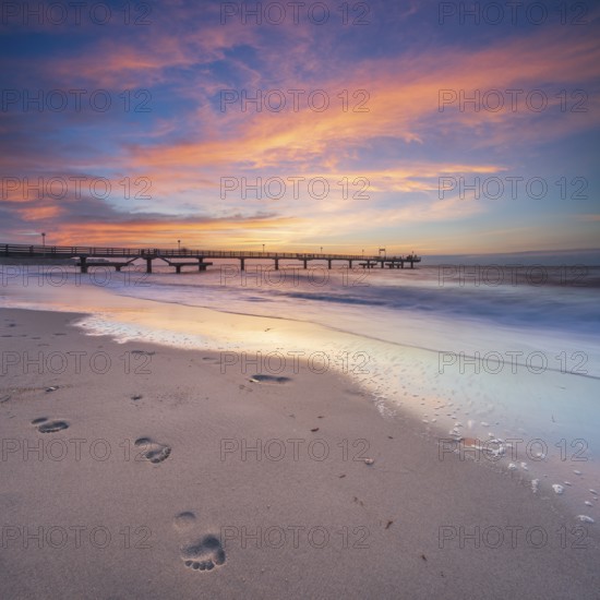 Pier on the fine sandy beach of the Baltic Sea at sunset, footprints in the sand, Baltic resort Rerik, Mecklenburg-Western Pomerania, Germany