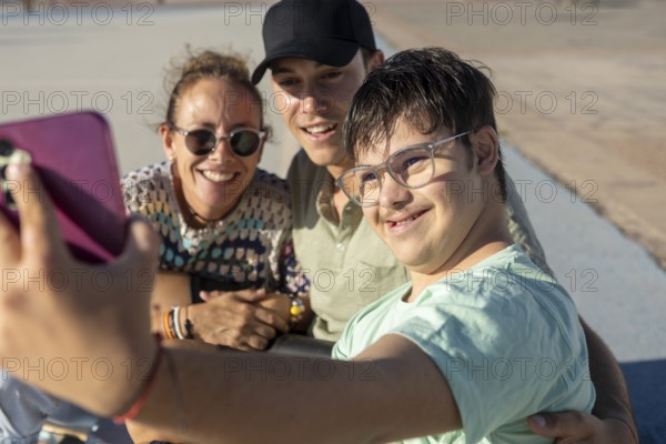 A Down syndrome teenager joyfully taking a selfie with family while enjoying a sunny day outdoors, highlighting family unity and the joy of sports and recreation together
