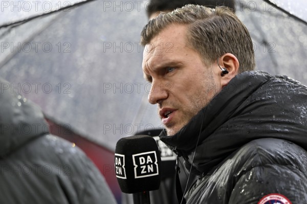 Sports board member Markus Krösche Eintracht Frankfurt SGE Portrait under screen in interview microphone Mikro Logo DAZN Regen, soccer Bundesliga, Allianz Arena, Munich, Bavaria, Germany
