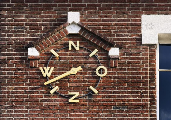 Wind clock on brick wall, Roermond, Limburg Province, Netherlands