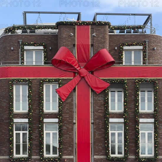 Large red ribbon on a house façade in the run-up to Christmas, Roermond, Limburg province, the Netherlands