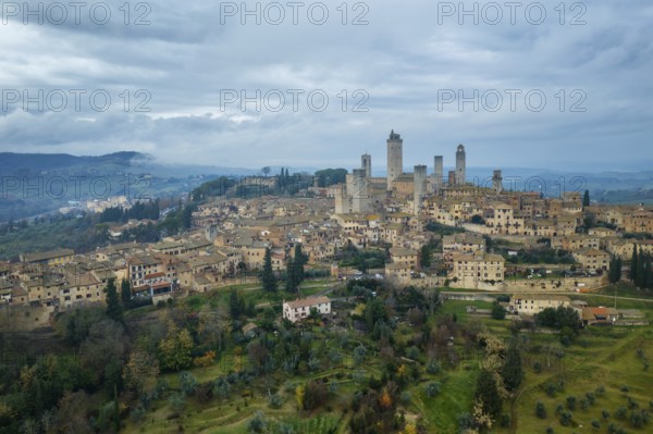 A captivating aerial view of San Gimignano, the historic hilltop town in Tuscany, Italy, famed for its medieval towers, stone buildings, and scenic countryside