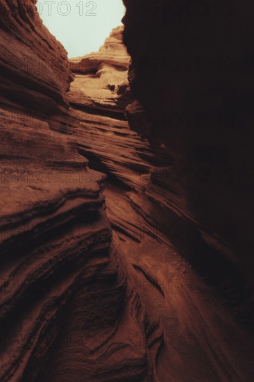Striking volcanic landscape of Lanzarote, featuring rugged canyon formations with layered rock patterns, showcasing nature's artistry and the island's unique geological history