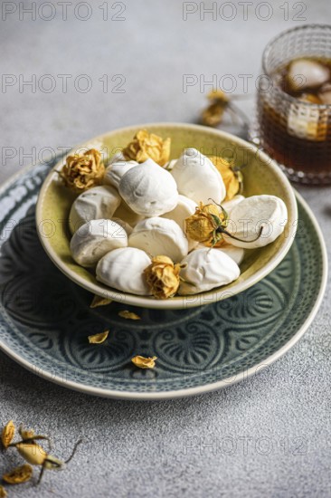 Homemade vanilla mini zephyr-marshmallows filled with rose jam, paired with a refreshing coffee liqueur drink on ice A perfect treat for sweet moments