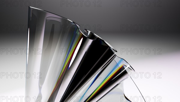 A close up of a sleek glass sculpture showcasing a stunning reflective prism effect. The dynamic curves and rainbow hues create a modern, artistic design in a minimalist setting