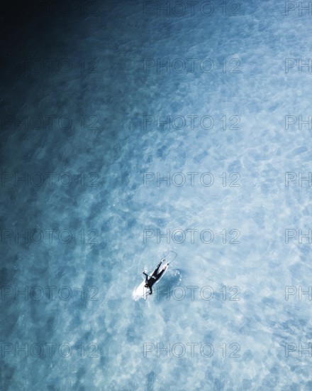 A captivating surf session in Portugal showcasing surfers navigating clear blue water. The image captures the thrill of surfing and the beauty of the sea in perfect harmony