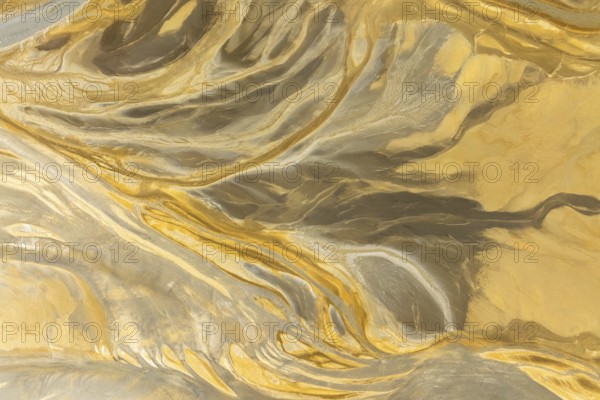 This image showcases a captivating abstract texture with flowing patterns resembling a marble surface in golden and beige hues Ideal for backgrounds or artistic designs