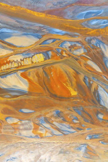A striking multicolor abstract texture showcasing dynamic flowing patterns in vivid orange, blue, and yellow hues The composition evokes a sense of movement and energy