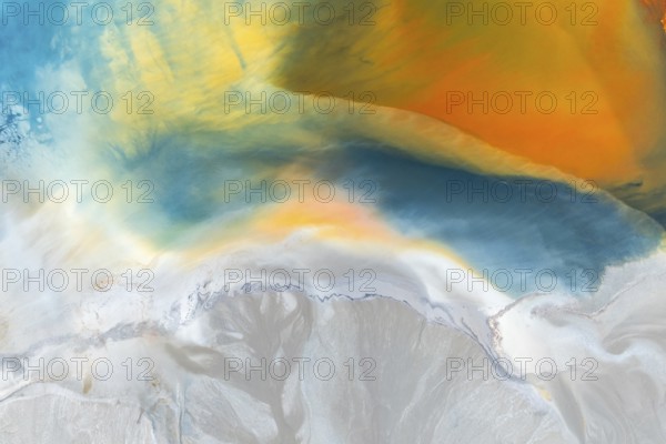 A vibrant abstract texture featuring a blend of multicolor swirls and organic patterns Rich blues, yellows, and oranges create a vivid, dynamic flow that evokes natural phenomena