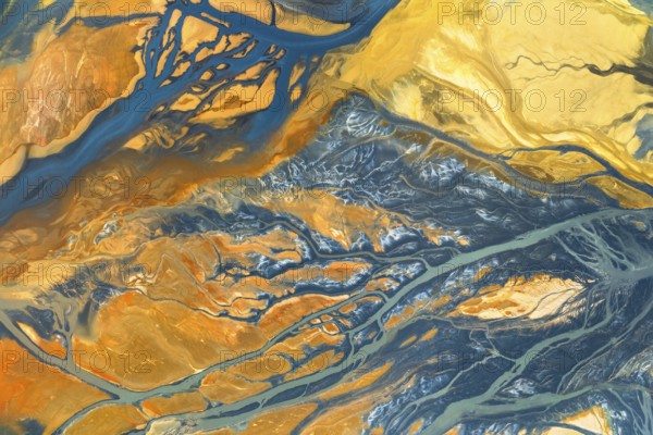 A vibrant abstract composition blending warm and cool tones in organic, flowing textures The intricate patterns evoke natural landscapes in an imaginative play of colors