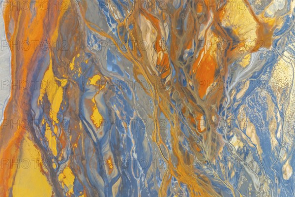 A vibrant abstract image showcasing dynamic swirling patterns in blue, orange, and yellow hues The colors blend seamlessly, creating an artistic and captivating visual experience