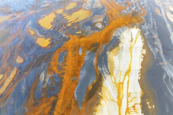 An intricate display of vibrant, swirling abstract textures featuring a dynamic blend of orange, blue, and white hues Perfect for adding energy and creativity to any design project