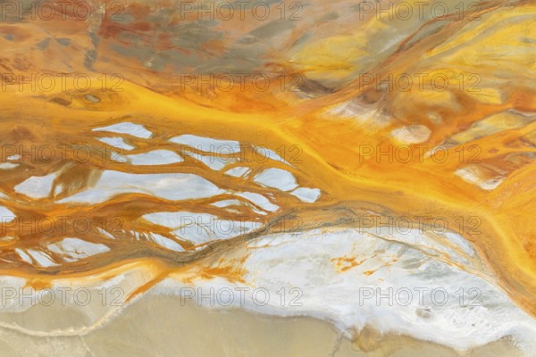 A stunning abstract composition featuring vibrant orange and white textures The fluid, organic patterns evoke a sense of movement and flow, creating a captivating visual experience