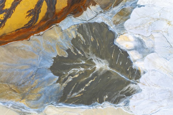 A stunning aerial view showcasing fluid multicolored abstract textures, resembling vibrant landscapes The interplay of colors creates an artistic and dynamic composition