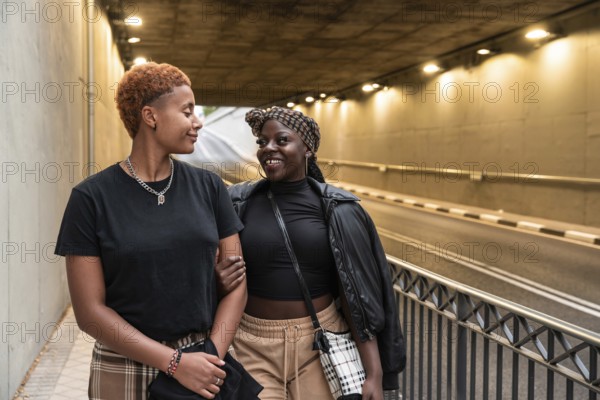 An LGBT multiethnic couple shares a joyful moment while strolling through an illuminated urban tunnel. They walk arm in arm, radiating happiness and connection