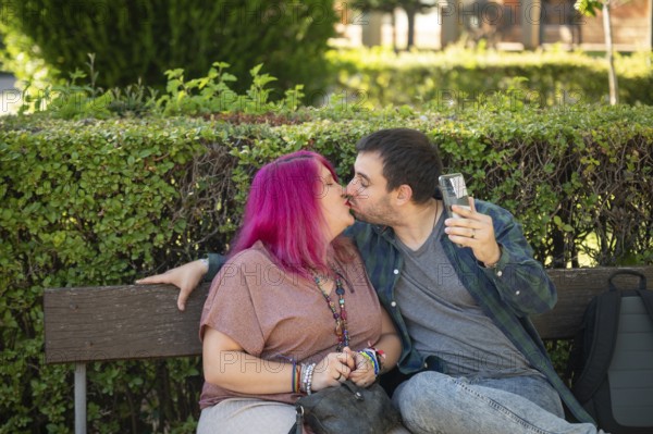 A college couple shares a tender kiss on a campus bench The woman, embracing life with a disability caused by spina bifida, radiates joy and connection with her partner