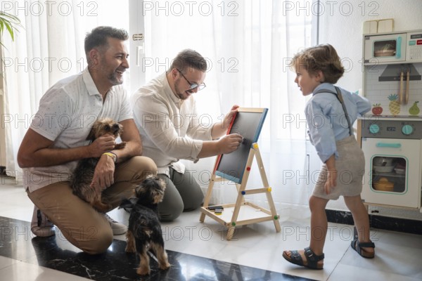 A joyful moment with a gay couple and their son, surrounded by joyful pets, sharing laughter and creativity at home. The scene radiates love and happiness