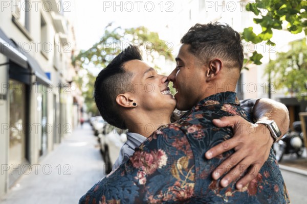 A joyful latin gay couple shares a tender embrace on a vibrant Madrid street. Capturing their love and happiness in an urban setting, this scene highlights LGBTQ+ pride and affection