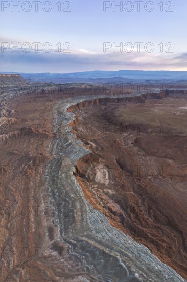 Stunning aerial view of Caineville Mesa in Utah, USA, showcasing vibrant layers of sedimentary rock formations The landscape captures the beauty of erosion and geological time