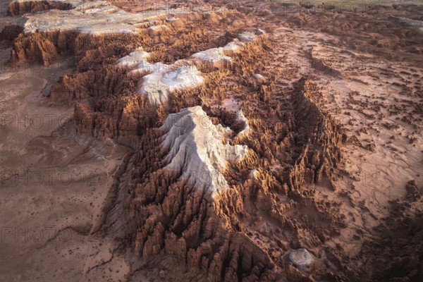 Aerial shot capturing the intricate rock formations and textured landscape of Goblin Valley State Park in Utah, highlighting varied hues and geological features