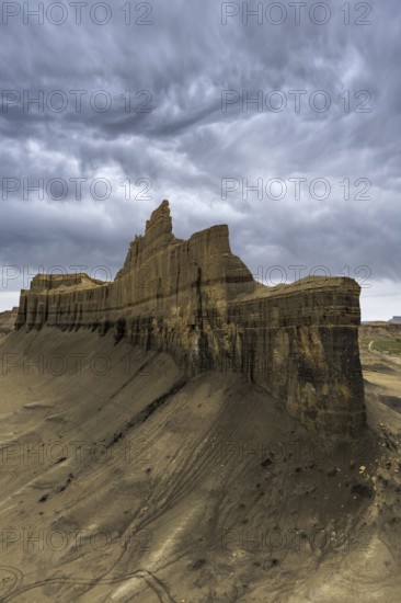 Moody clouds loom over the rugged Caineville Mesa in Utah, USA, highlighting the dramatic landscape and striking rock formations in this natural wonder