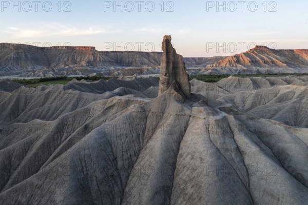 Captivating view of Caineville Mesa, Utah, showcasing striking erosion patterns and rugged terrain under a serene sky The dramatic landscape highlights nature's artistry