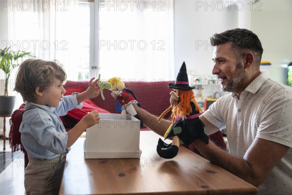 A heartwarming scene of a father engaging in playful puppet storytelling with his young son. Vibrant and cozy home atmosphere emphasizes family love and connection