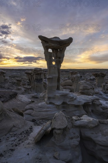 Stunning rock formations in Bisti De-Na-Zin Wilderness, New Mexico, USA Rugged, surreal landscape under a dramatic sunset sky, capturing the beauty of the desert