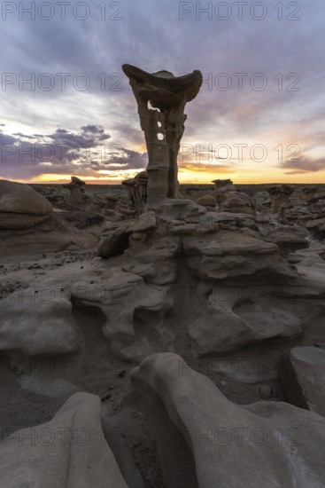 A captivating rock formation in Bisti De-Na-Zin Wilderness, New Mexico, USA, bathed in the warm glow of sunrise The unique geological shapes evoke a sense of alien landscapes