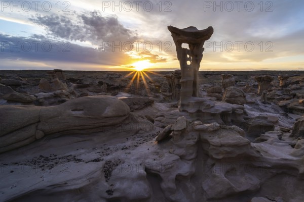 Captivating sunrise over unique hoodoo formations in Bisti De-Na-Zin Wilderness, New Mexico, USA Dramatic sky and desert landscape create an ethereal natural scene