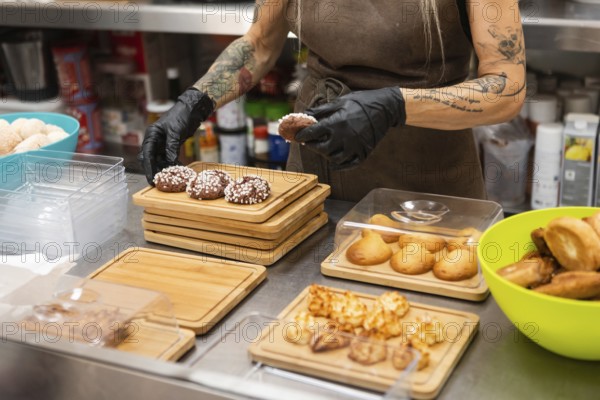 An Italian bakery scene features a person arranging freshly baked pastries on wooden trays The worker wears gloves, creating a hygienic and artisanal atmosphere