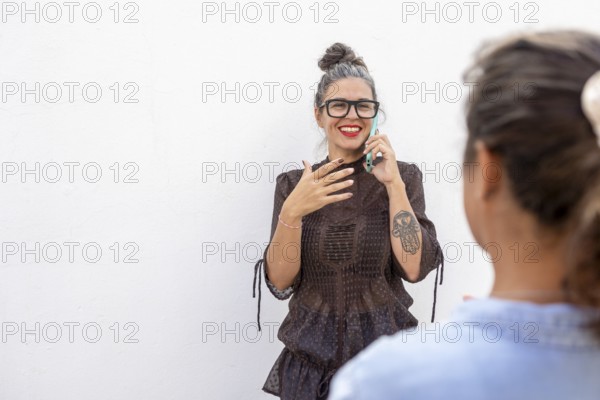 A smiling woman using sign language during a lesson She engages with another person, demonstrating expressive communication Ideal for education and inclusivity themes