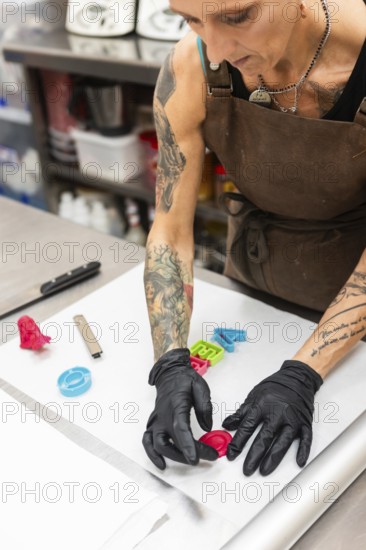 A skilled artisan in an Italian bakery decorates fondant Wearing gloves and an apron, they craft colorful shapes, embodying creativity and precision in a bustling kitchen