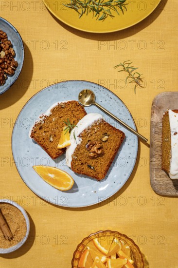 Slices of carrot cake loaf topped with rich cream cheese frosting and garnished with walnuts and rosemary on a linen backdrop A perfect dessert setup with vibrant colors