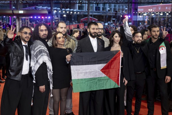 Actors and crew of the film Chronicles From the Siege hold a flag of Palestine on the Red Carpet ahead of the 76th Berlinale closing gala at the Theater am Potsdamer Platz Berlin on 21.02.2026. The 76th Berlin International Film Festival will take place from February 12 to 22, 2026