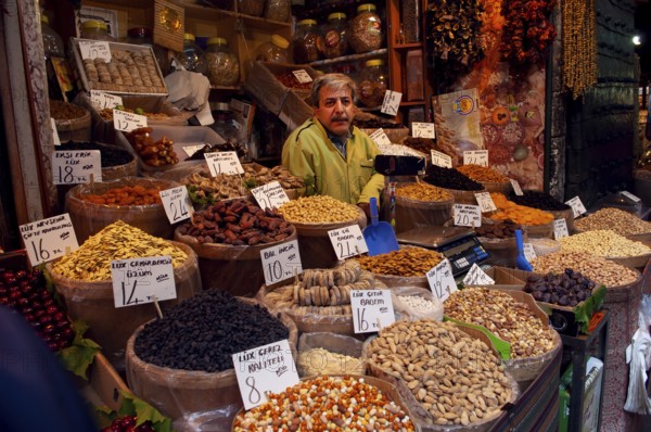 Istanbul, Turkey. May 20th 2010 A Turkish stall holder selling dried fruit and nuts inside the Spice Bazaar, Istanbul, Turkey