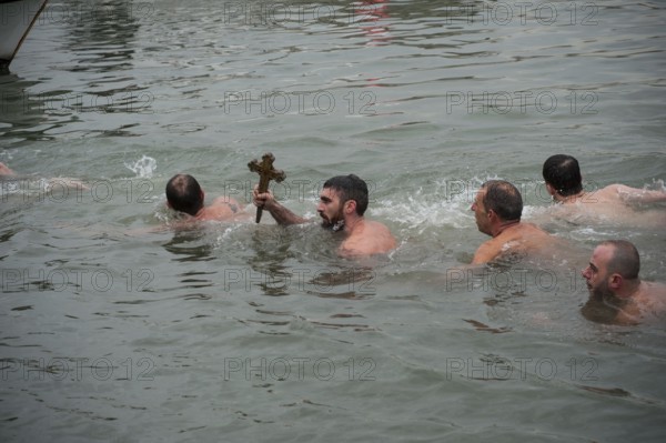 Istanbul, Turkey, January 6th 2017 A man holds a wooden cross after retrieving it from the Golden Horn, celebration of Epiphany at the Church of Fener Orthodox Patriarchiate in Istanbul, Turkey