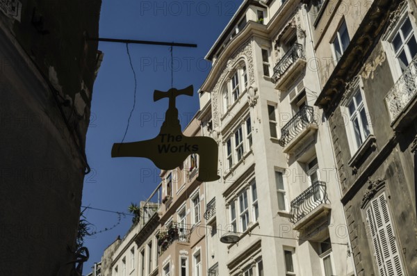 Istanbul, Turkey. 14th May 2015 The Works Antique shop sign hangs in front of typical European style architecture in Cihangir neighbourhood, Istanbul, Turkey