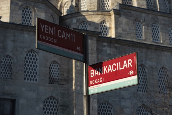 Street sign for Yeni Cami Caddesi and Bankacilar Sokagi behind the New Mosque in the Fatih district of the European side of Istanbul, Turkey