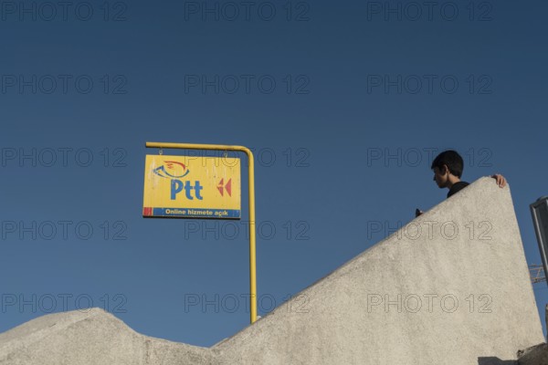 Istanbul, Turkey. October 3rd 2021 Bright Yellow PTT sign, the Turkish Post Office against a deep blue sky in the largest city in Turkey