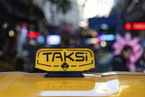 Istanbul, Turkey. November 10th 2022 An illuminated yellow Turkish taxi sign on a car parked in the busy nightlife district of Beyoglu, Istanbul, Turkey