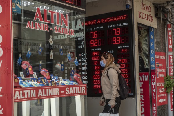 Istanbul, Turkey. November 28th 2020 A woman wearing a protective facemask enters and currency and gold exchange office, Turkey is currently dealing with both a volatile economic crisis and rise in Covid-19 infection rates