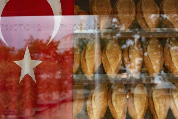 Istanbul, Turkey. October 12th 2021 Traditional Turkish bread loafs for sale inside a typical bakery window beside a Turkish flag