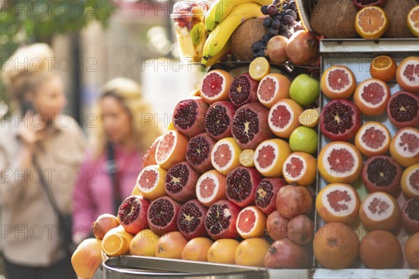 Brightly colored fresh and healthy fruit such as pomegranates and oranges for sale at a juice stall in Istanbul, Turkey