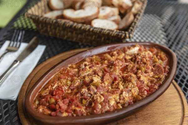 Istanbul, Turkey. August 3rd 2021 Turkish breakfast dish of Menemen with Eggs, Cheese, Tomatoes, and Peppers served with bread in a Cafe in Istanbul, Turkey