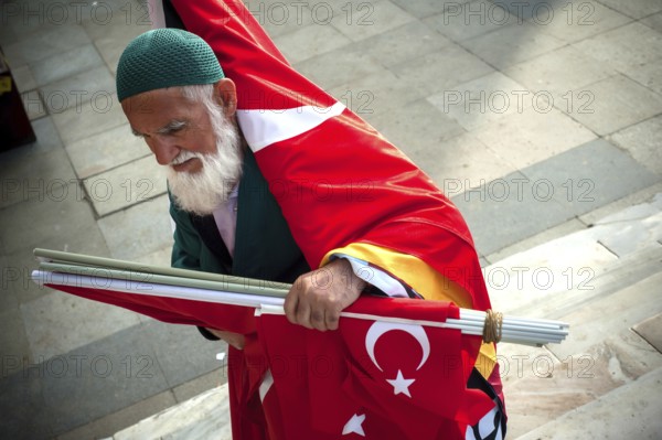 Istanbul, Turkey. May 6th 2016 A bearded Turkish man selling flags on the streets of Istanbul, Turkey