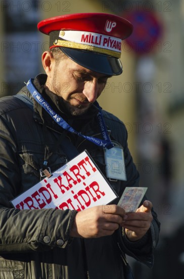 Istanbul, Turkey. December 19th 2014 A man selling Turkish lottery tickets near Takism square, Istanbul, Turkey