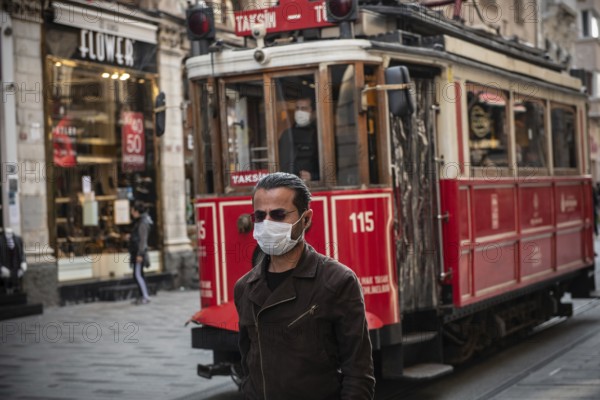 Istanbul, Turkey. November 28th 2020 A man wearing a surgical face mask along Istiklal Street, Istanbul, wearing masks in public spaces is mandatory in Turkey