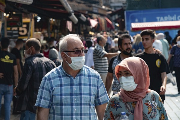 Istanbul, Turkey 25th August 2021 A Turkish couple wearing protective face masks in a busy market in Istanbul, Turkey during the Covid-19 Pandemic